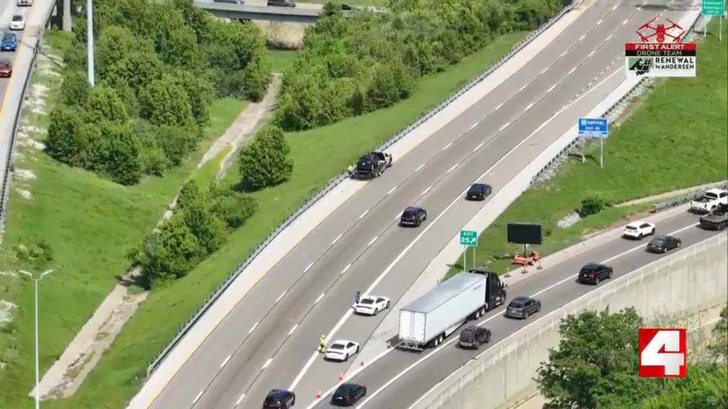 Aerial view of a multi-lane highway with an accident causing traffic congestion.
