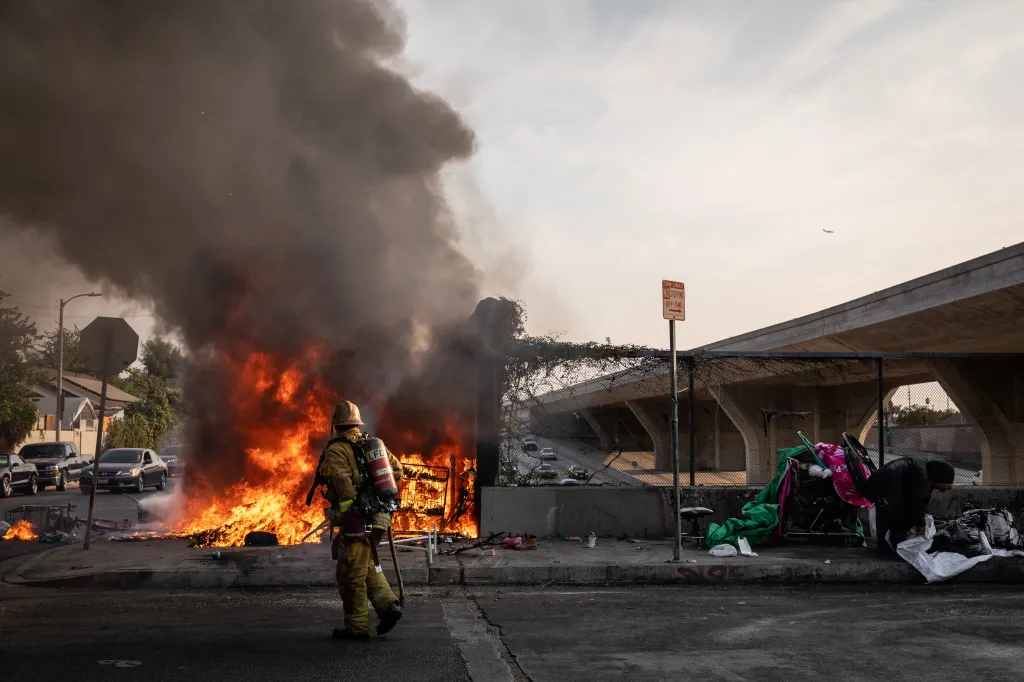 Los Angeles Fire Department personnel battling a fire at a homeless encampment.