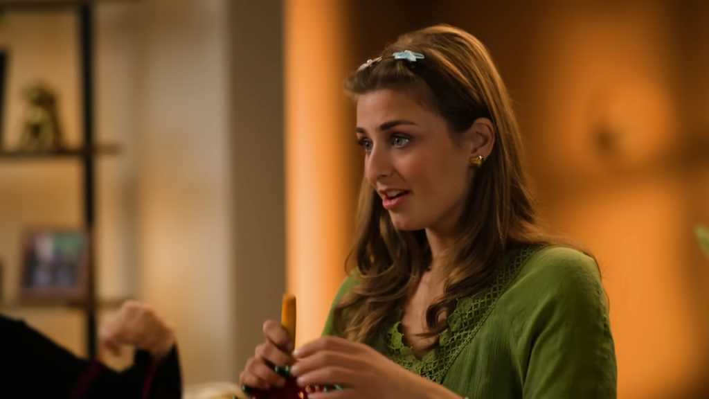 Abbey Romeo from Love on the Spectrum holding an orange object and talking.