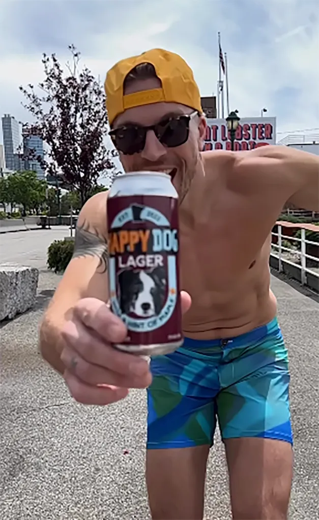Luke Gulbranson holding a can of Happy Dog Lager.