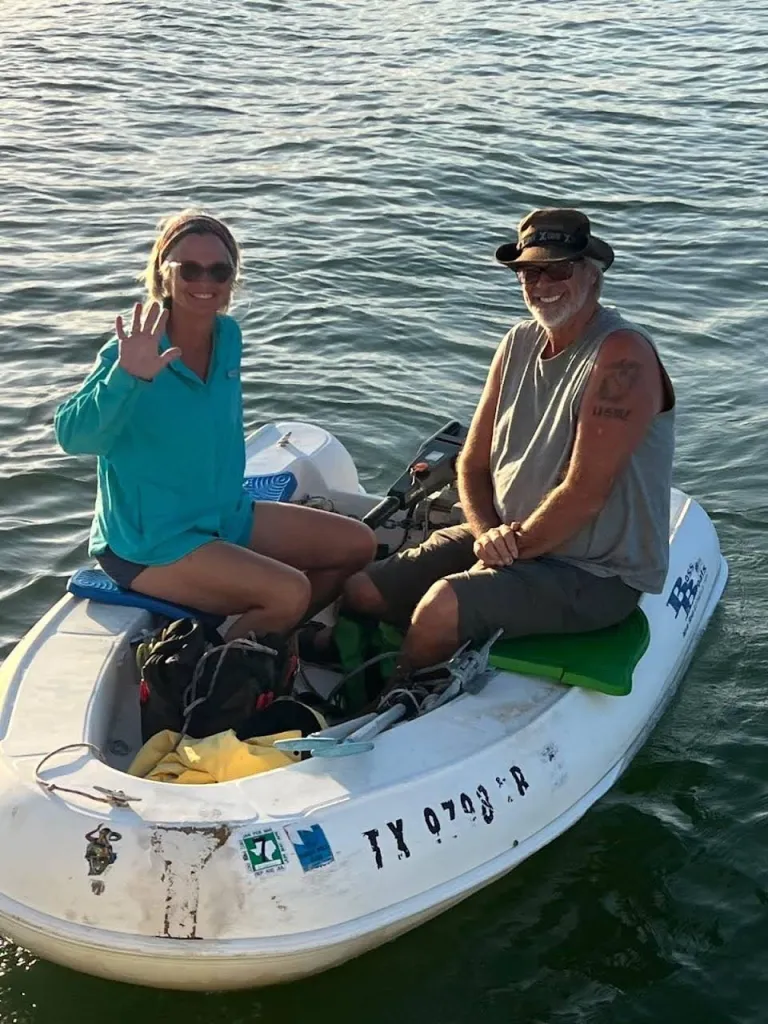 Lynette and Brian Hooker in a small white boat on the water.