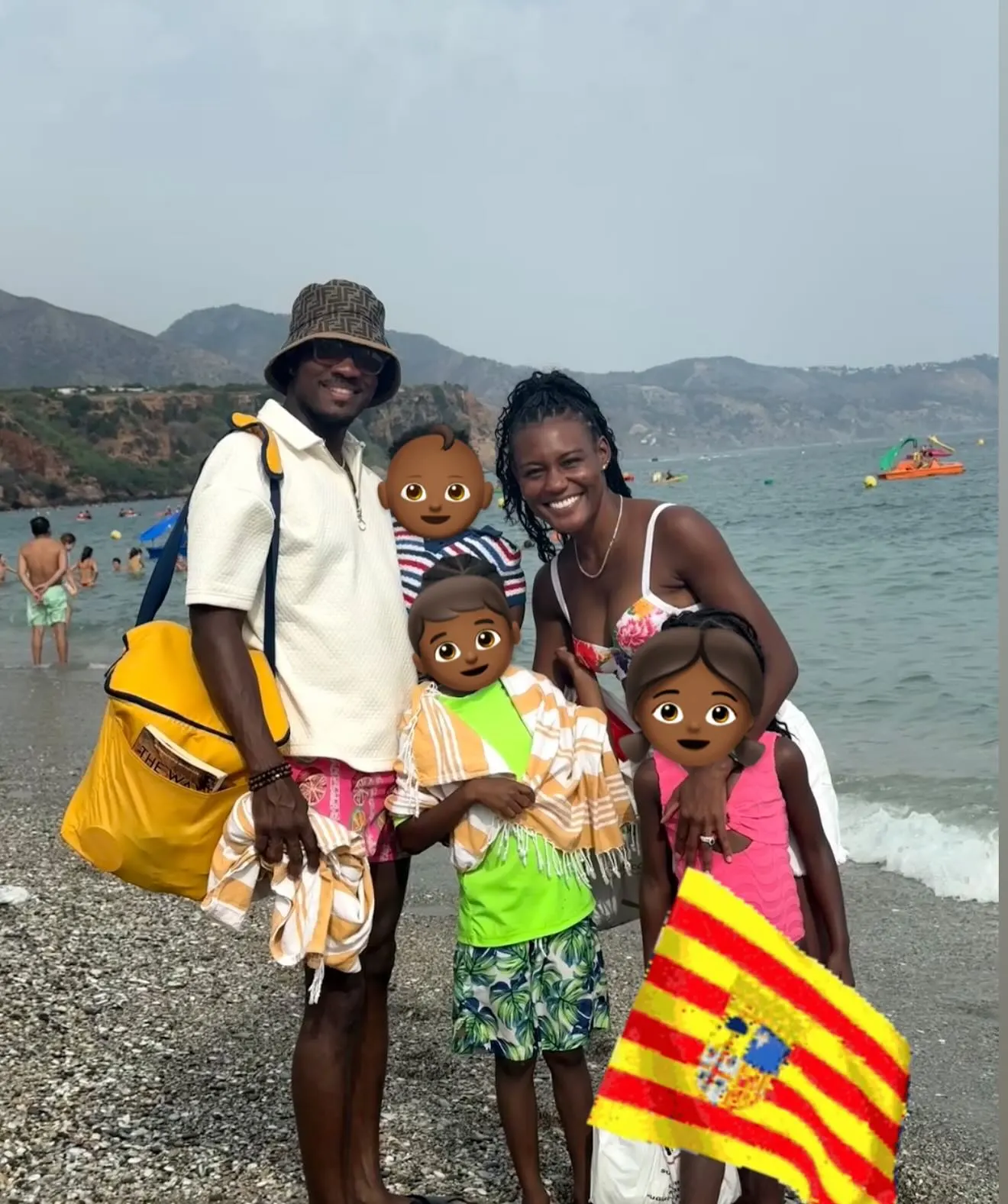 Janai Norman with her family on a beach.