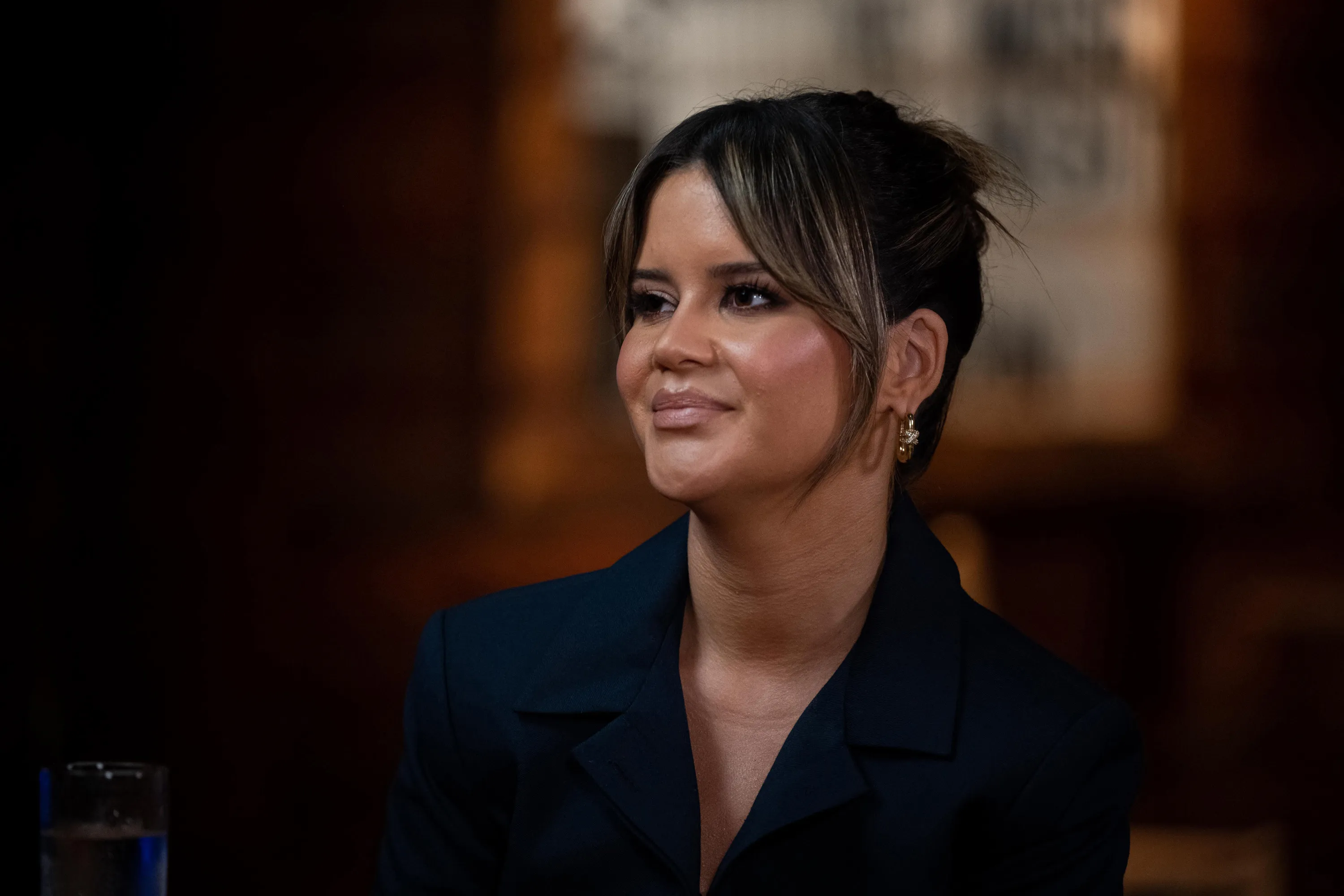 Maren Morris in a dark blazer with her hair pulled back.