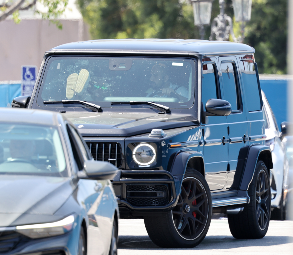 Britney Spears with her feet on the dashboard of her Mercedes G-Wagon.