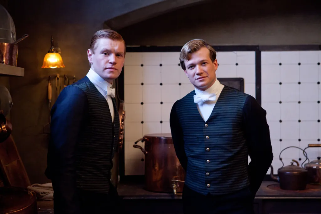 Matt Milne and Ed Speleers in tuxedo vests.