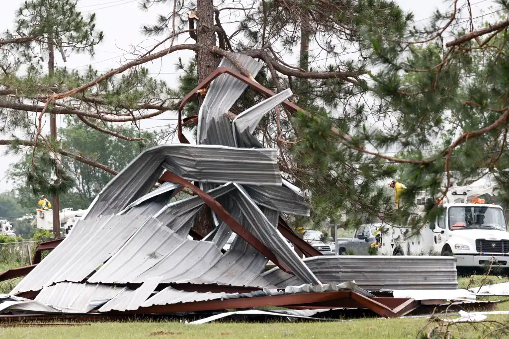 A twisted metal building rests among tree branches after a tornado in Springtown, Texas.