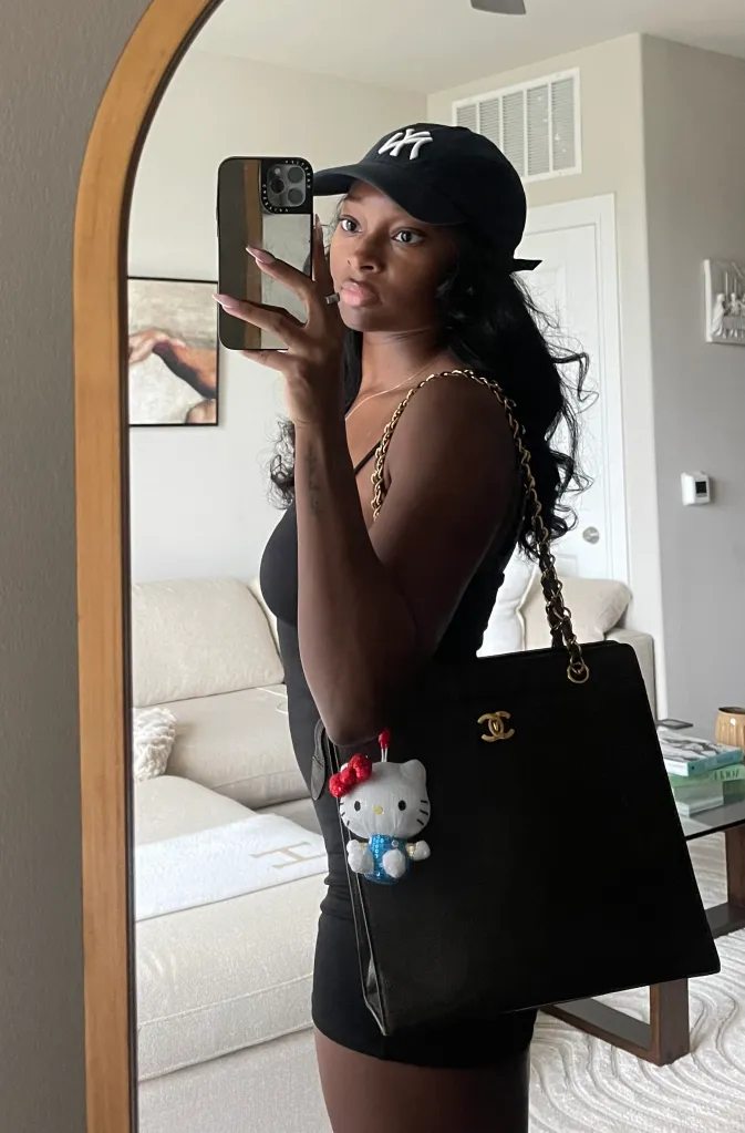 Melanie Moon poses with a vintage designer bag.