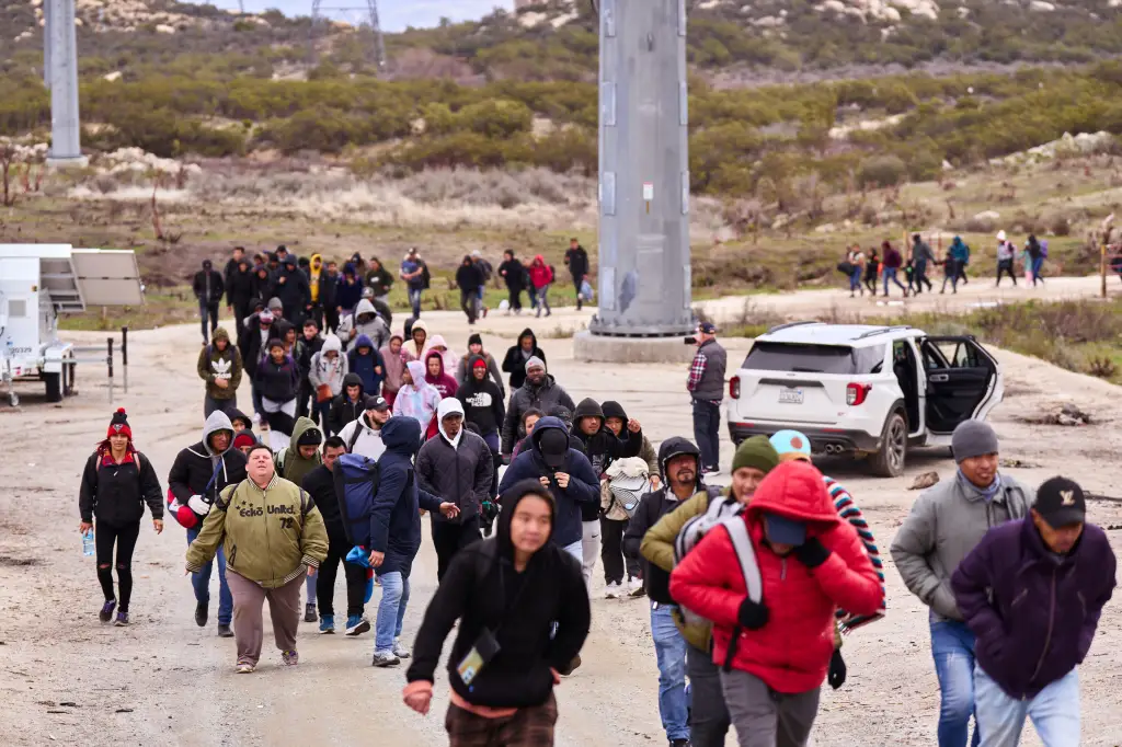 Migrants walk on a dirt road in Boulevard, California, after crossing the U.S.-Mexico border.