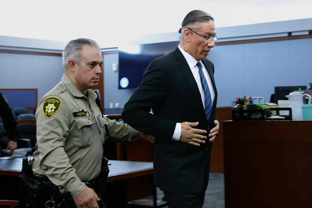 Nathan Chasing Horse is led out of a courtroom by an officer after a jury found him guilty of sexual assault.