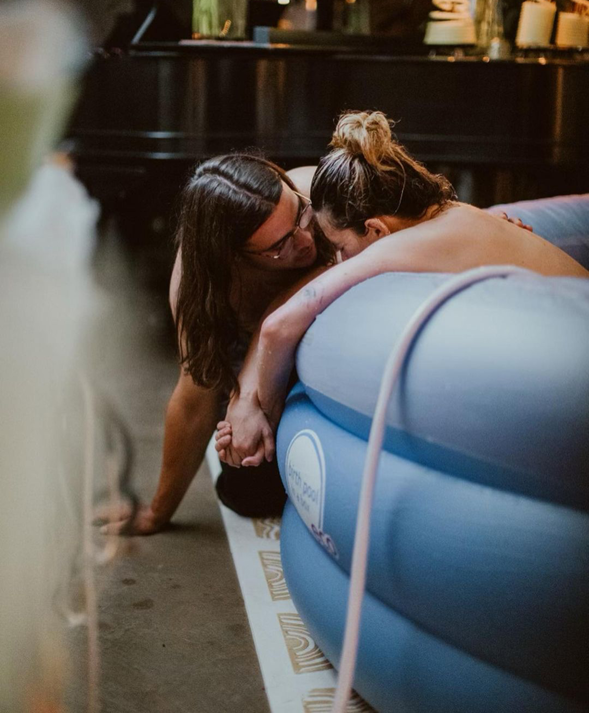 Rumer Willis and her ex on the side of a blue inflatable birth pool.
