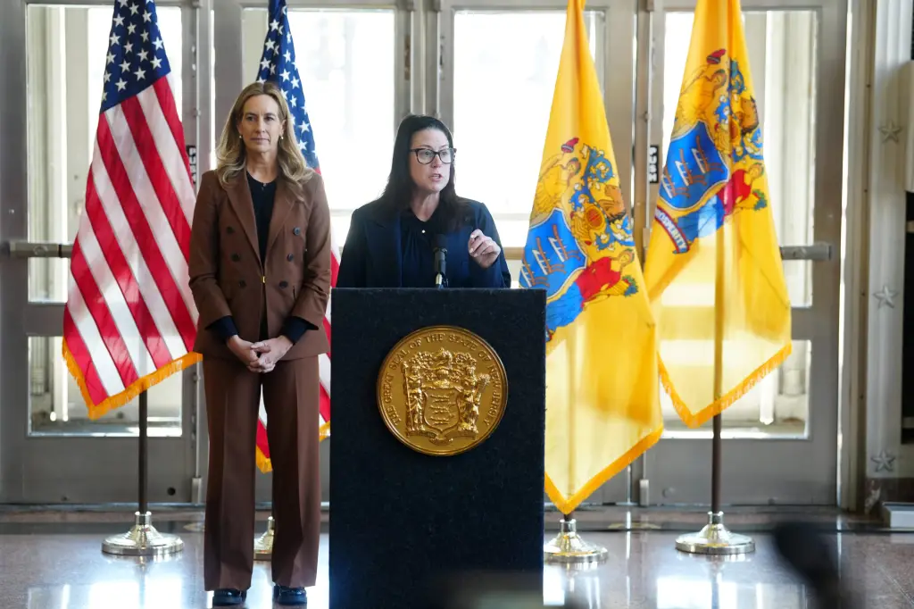 Jennifer Davenport, Acting Attorney General of New Jersey, speaks at a podium.