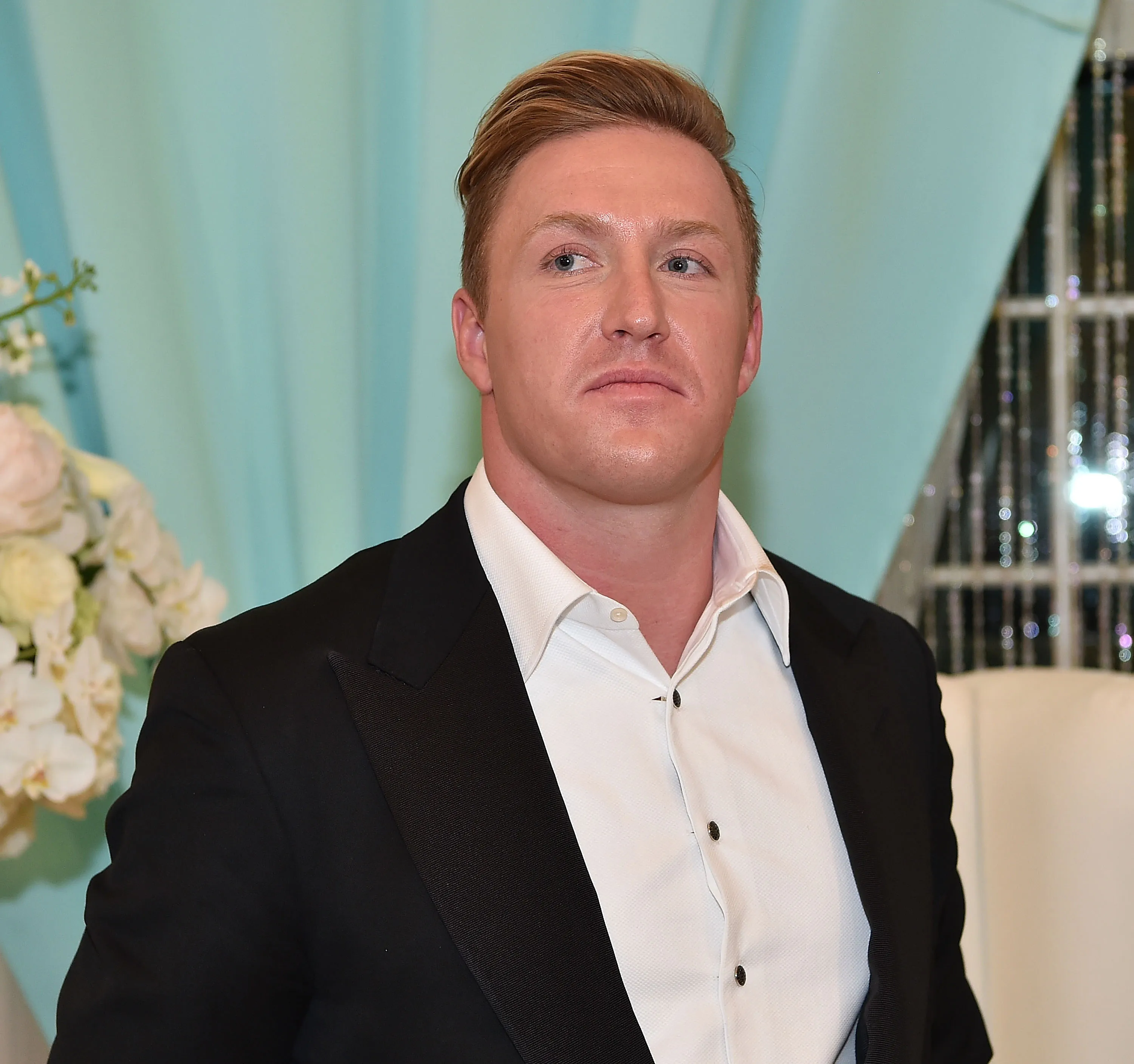 Retired NFL player Kroy Biermann wearing a black suit jacket and white shirt.
