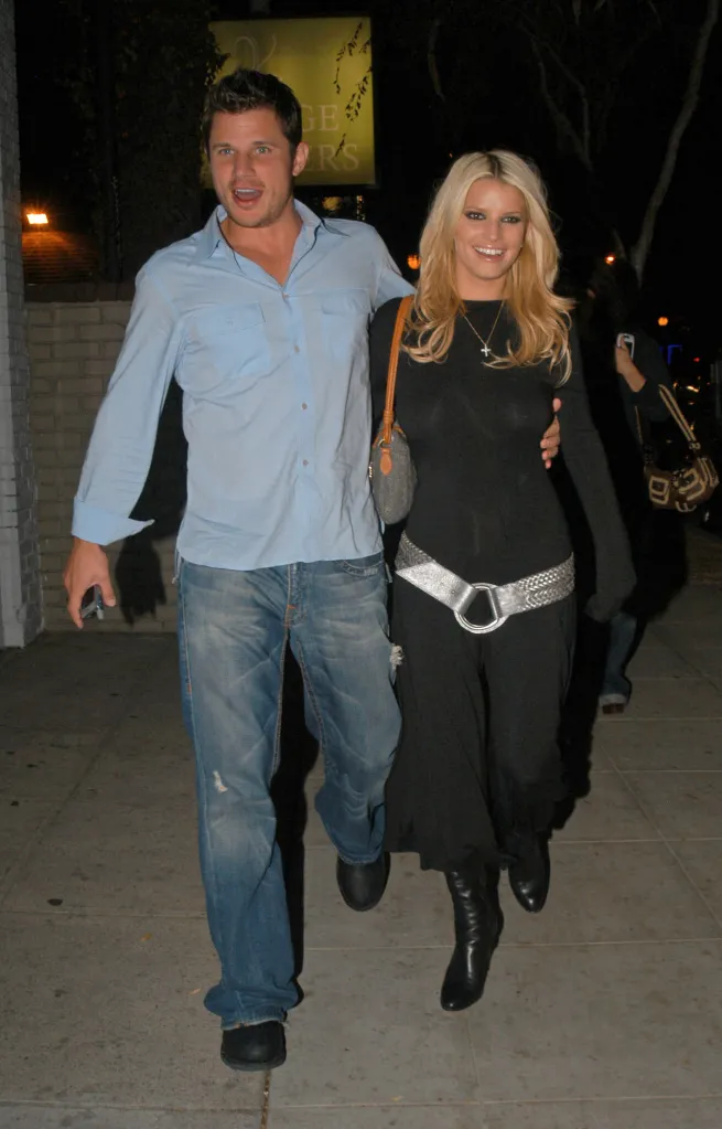 Nick Lachey and Jessica Simpson walk together at night.