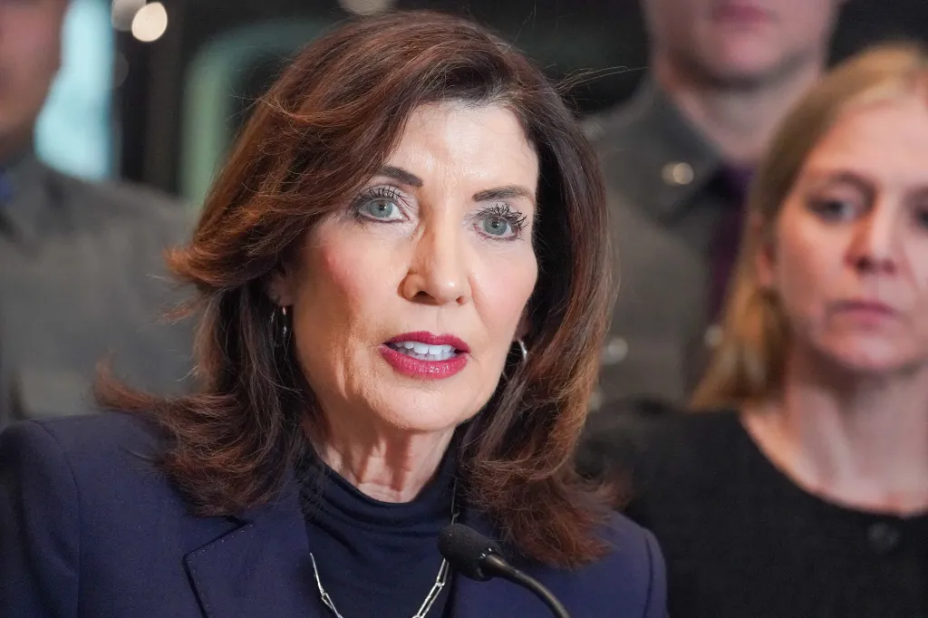 Kathy Hochul speaking at a podium with a microphone.