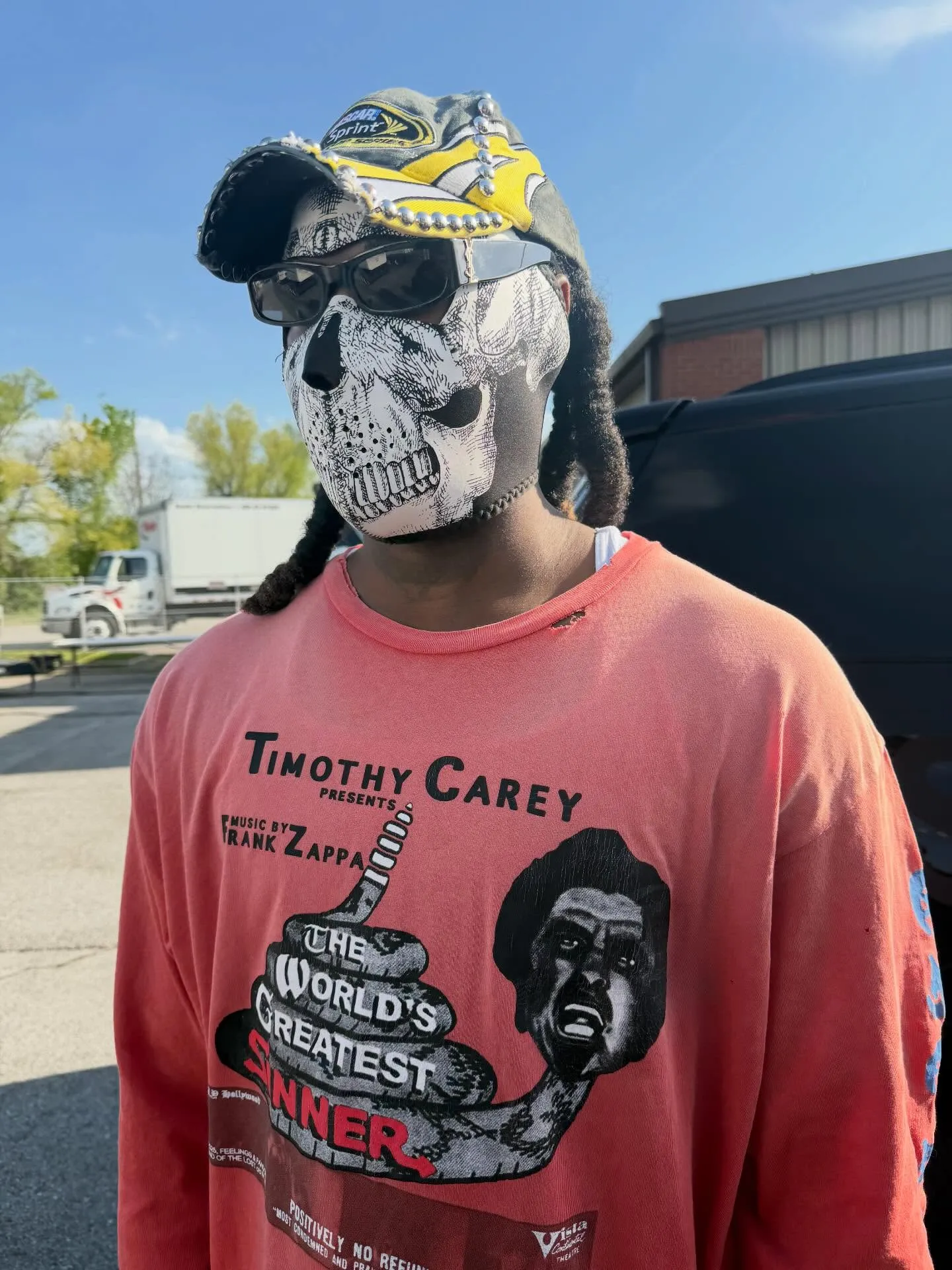 Offset wearing a skull mask, sunglasses, a baseball cap, and a