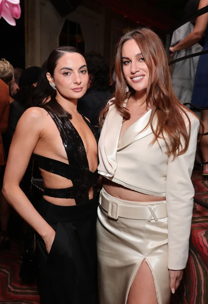 Paige DeSorbo in a black sequin dress and Hannah Berner in a cream satin outfit.