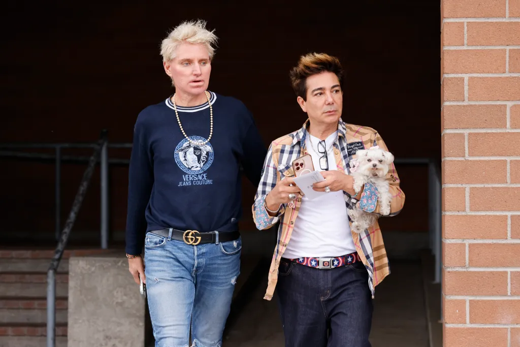 Patrik Simpson and Pol Atteu leaving the LAPD Hollywood Station after filing a police report.