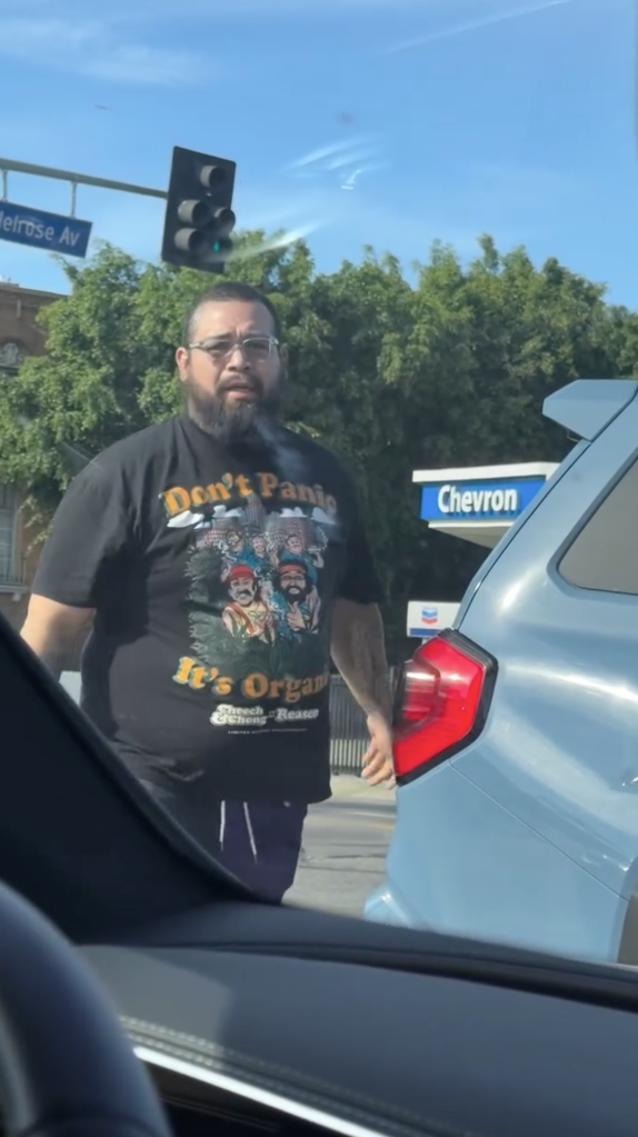 Man approaching car in a road rage incident.