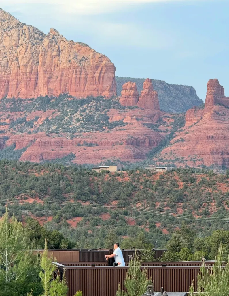 Mike Vrabel with Dianna Russini on a balcony overlooking red rock formations.