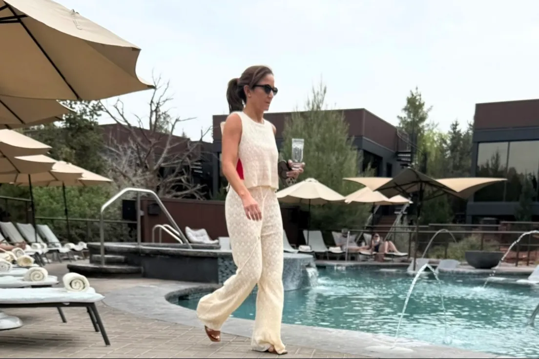 Dianna Russini walking poolside at Ambiente Sedona hotel.