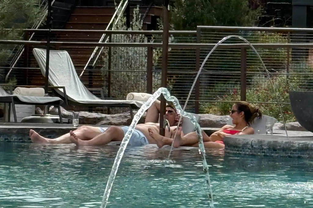 Mike Vrabel and Dianna Russini relaxing in a pool.