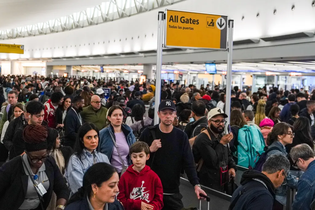 People wait in long TSA security lines at John F. Kennedy International Airport (JFK).
