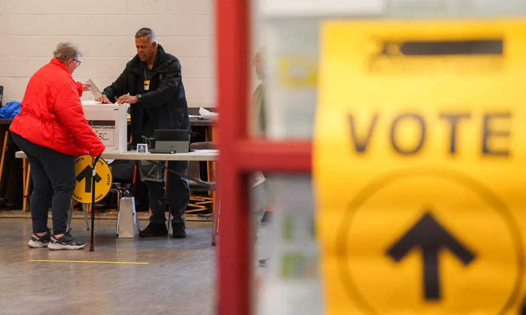 A person casts their vote at a polling station, at the Scarborough Village Recreation Centre in the Scarborough Southwest riding in Toronto, Ontario on April 13, 2026.