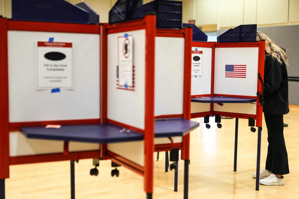 A person casting a ballot in a voting booth in Virginia.