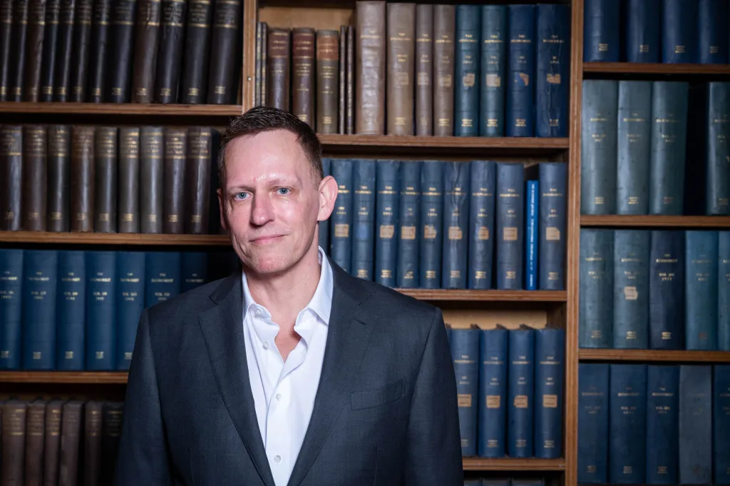 Peter Thiel, co-founder of PayPal, in front of a bookshelf.