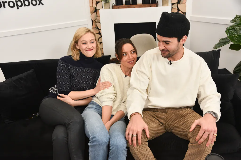 Sarah Gadon, Aubrey Plaza, and Christopher Abbott sit on a couch.