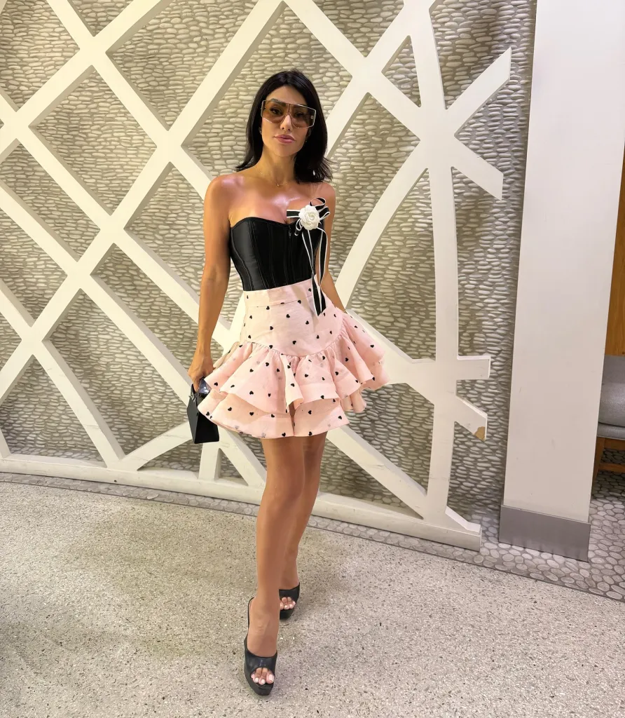 Hamideh Soleimani Afshar in a black corset and a pink ruffled skirt with heart patterns.