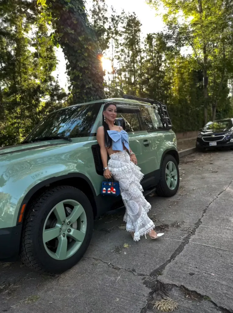 Hamideh Soleimani Afshar leaning against a green Land Rover.