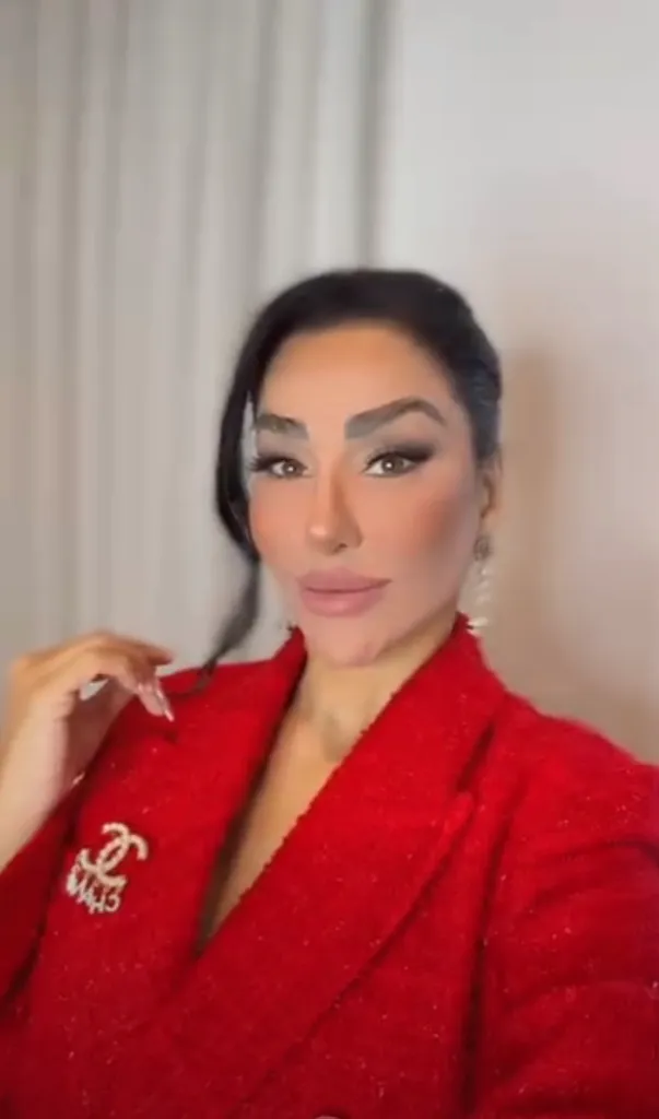 Hamideh Soleimani Afshar wearing a red jacket with a sparkly brooch.