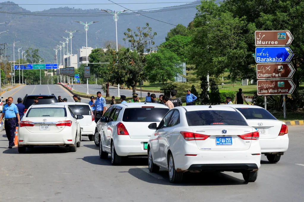 Police officers conduct security checks on vehicles in Islamabad, Pakistan.