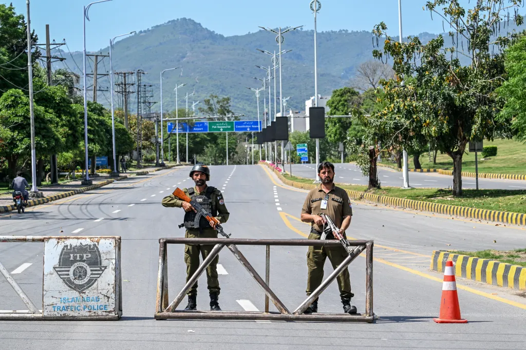 Police personnel standing guard at a closed road in Islamabad.