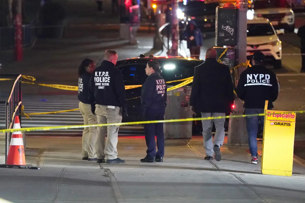 NYPD officers at the scene where an armed man was shot on W125th Street near Amsterdam Avenue.