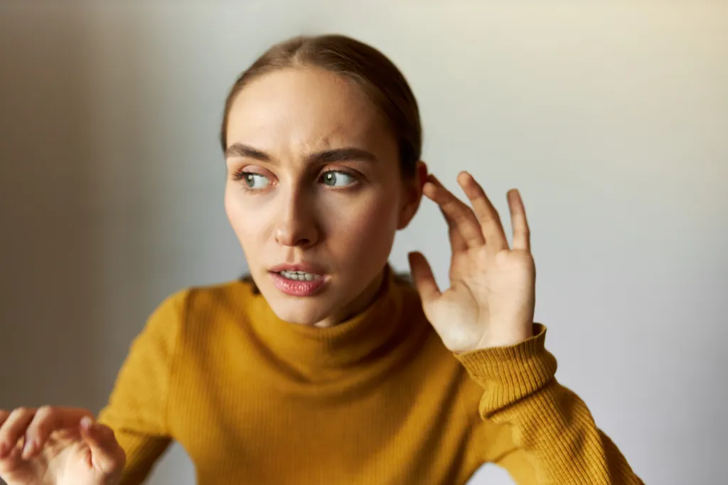 Woman listening to something eery. 