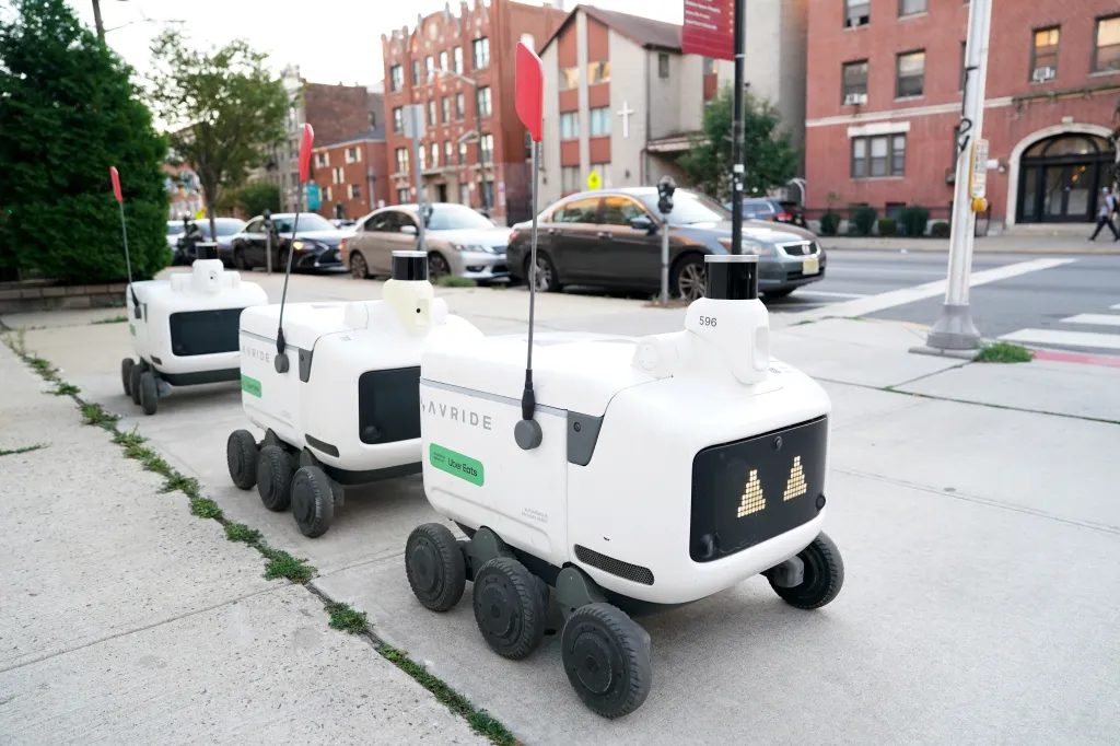 Uber Eats food delivery robots on a sidewalk in Jersey City.