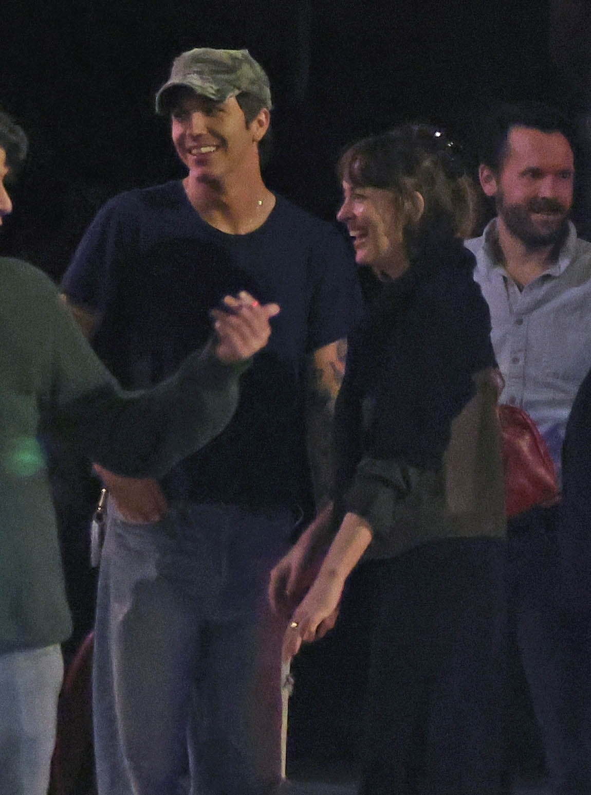 Dakota Johnson and Role Model laughing and smiling while on a night out with friends.