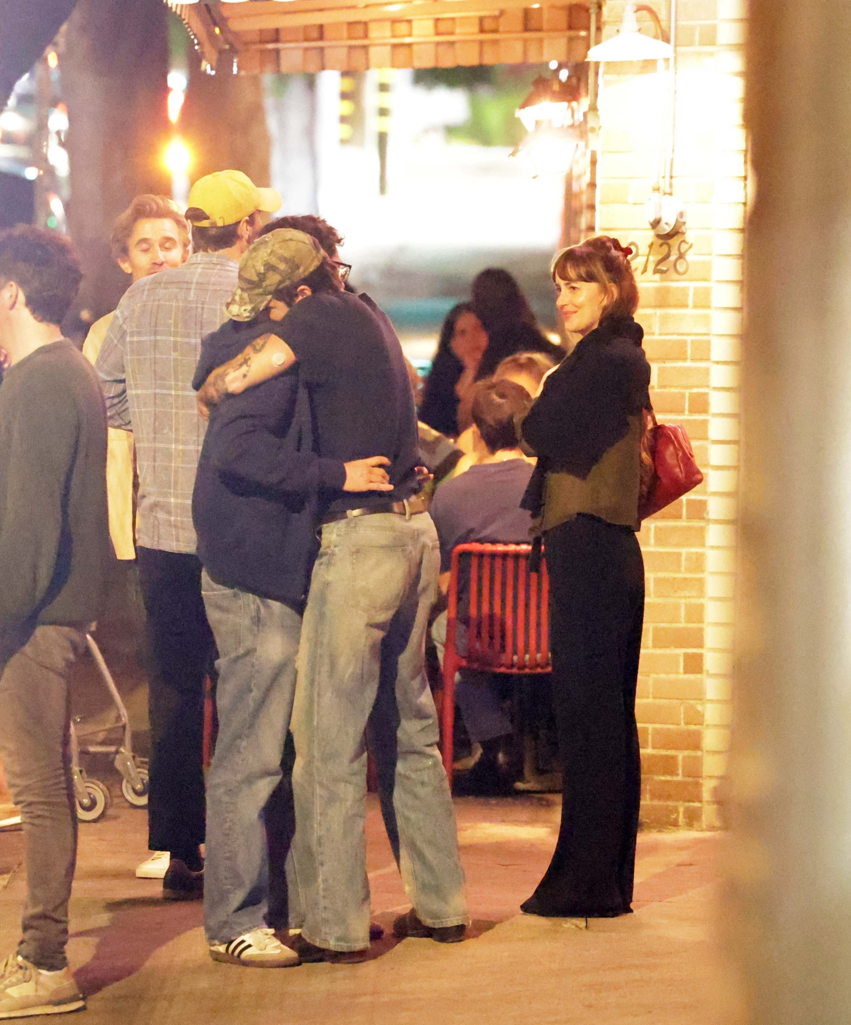 Dakota Johnson with Role Model and friends at a restaurant.