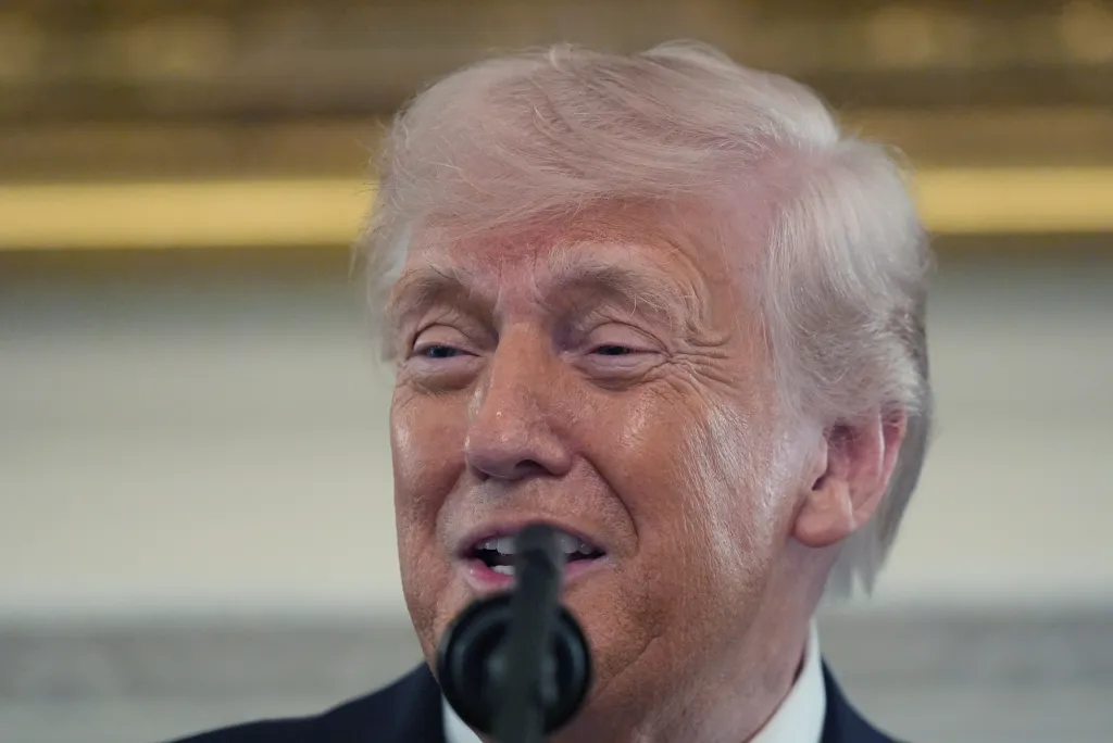 President Donald Trump speaks at a podium.