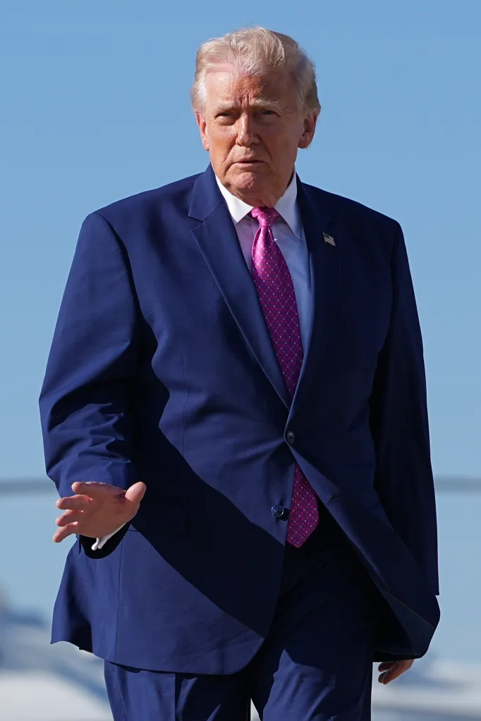 President Donald Trump waves while boarding Air Force One.
