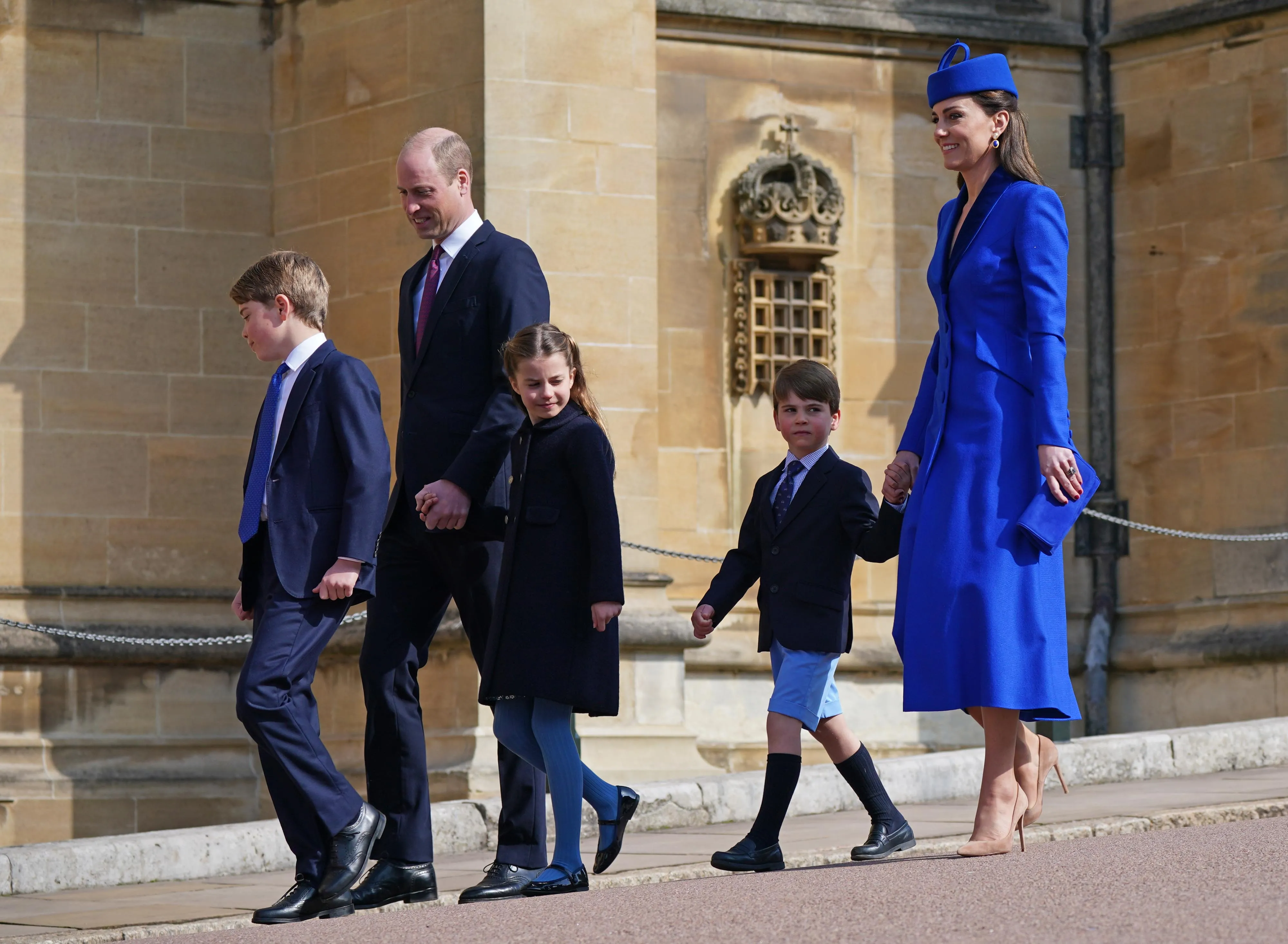 Prince George, Prince William, Princess Charlotte, Prince Louis, and Catharine, Princess of Wales, walk together.