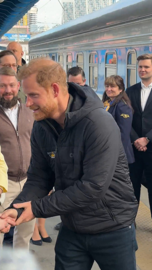 Prince Harry is greeted after stepping off a train during an unannounced visit to Ukraine on April 23, 2026.