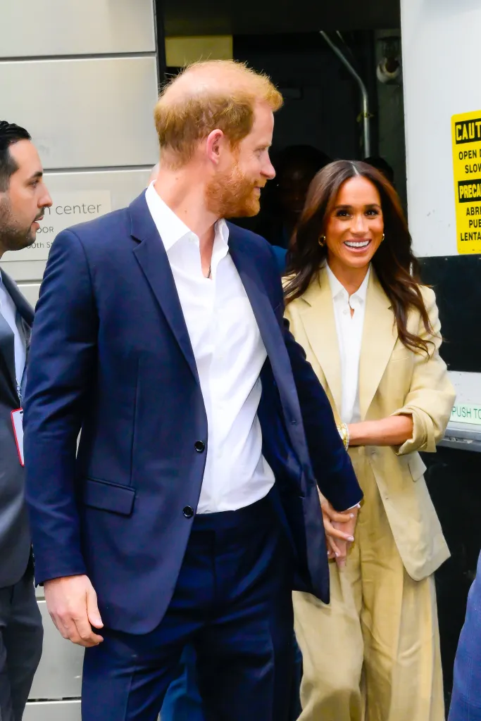 Prince Harry, Duke of Sussex, and Meghan, Duchess of Sussex, walking and holding hands.