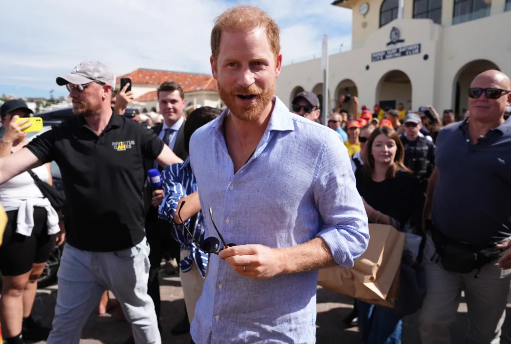 Prince Harry among people at Bondi Beach, Australia.