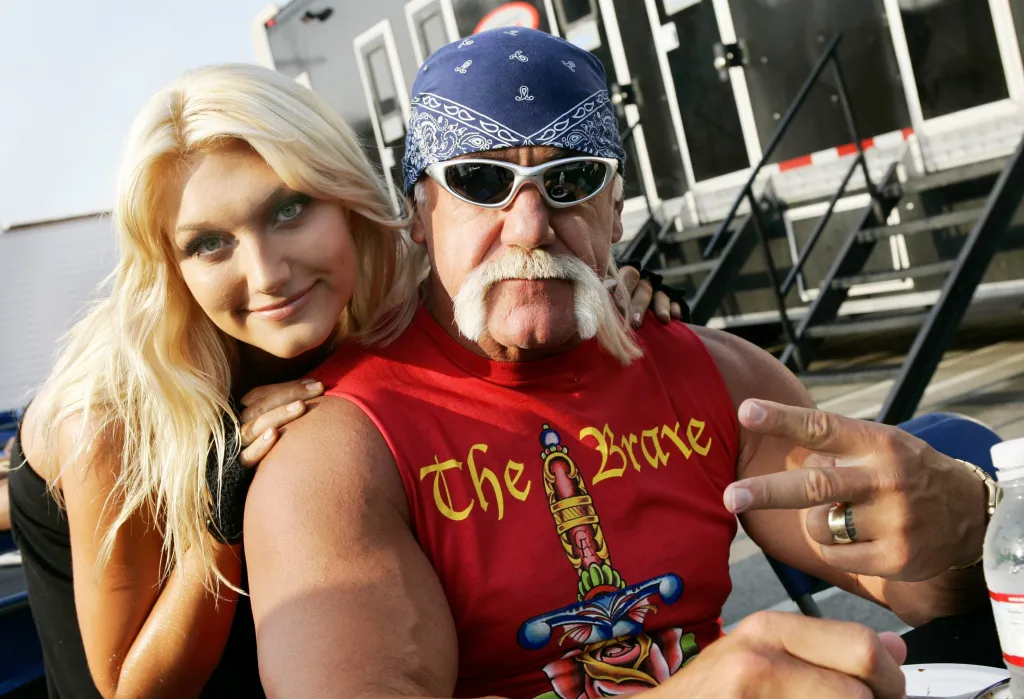 Hulk Hogan and daughter Brooke Hogan pose together on set.