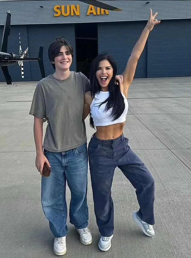Lauren Sánchez with her son Evan on an airfield with a 