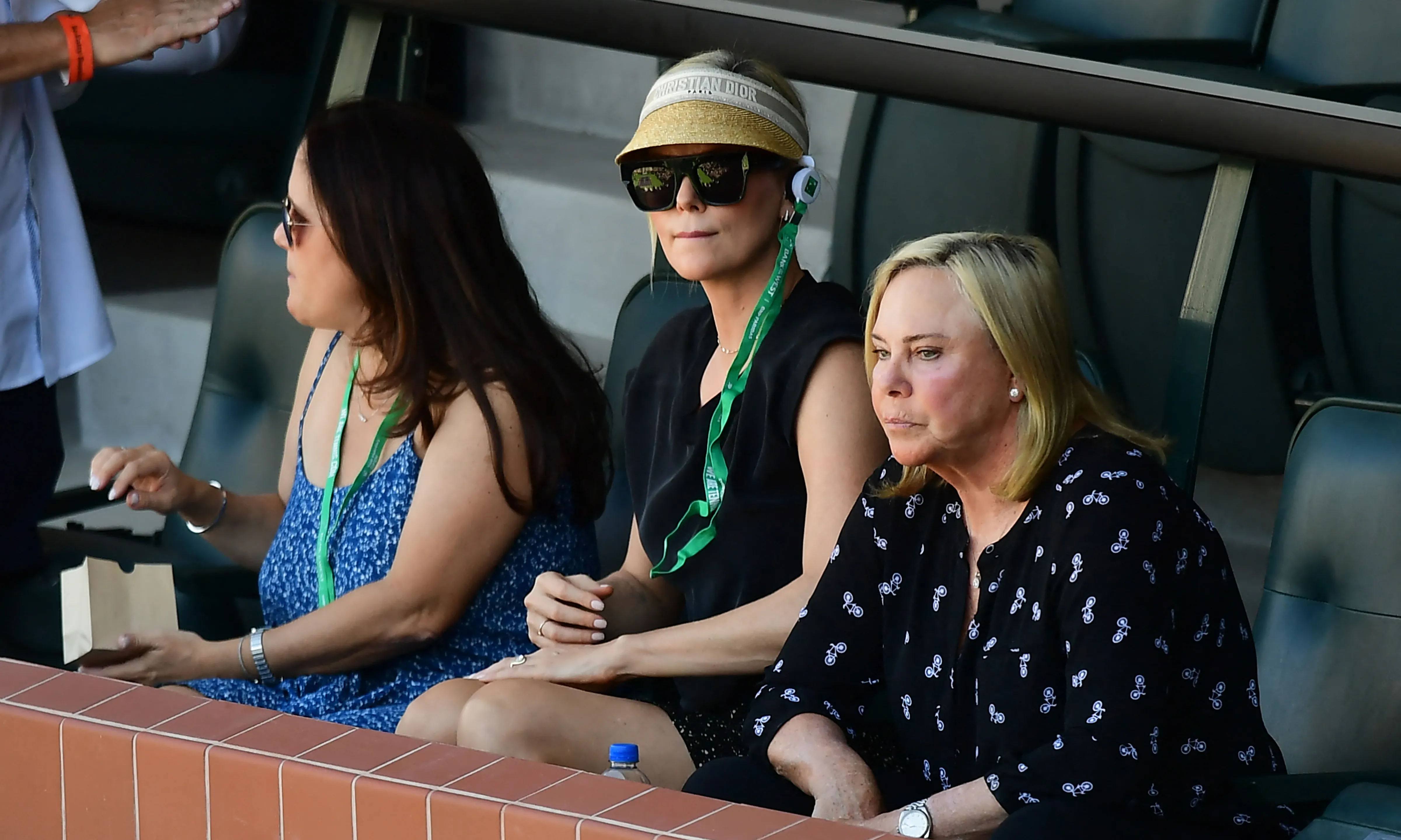 Charlize Theron and her mother Gerda Jacoba Aletta Maritz watching a men's semifinal tennis match at Indian Wells.