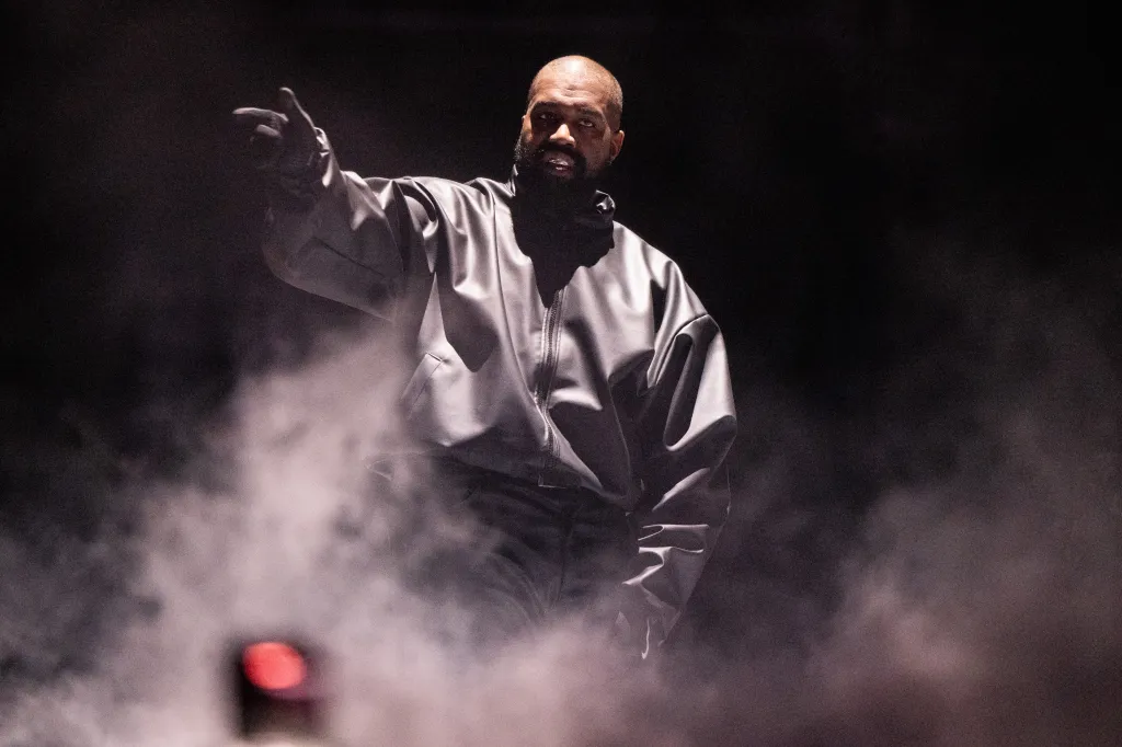 Rapper Kanye West performing onstage.